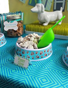 a bowl filled with food on top of a blue and green tablecloth covered table