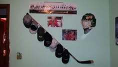 there are hats and hockey stick hanging on the wall