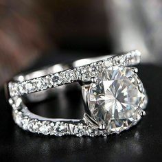 a diamond ring on top of a black surface