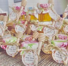 a table topped with lots of small baskets filled with honey