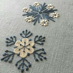 three snowflakes are shown on a table cloth