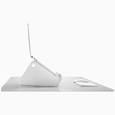 an apple laptop computer sitting on top of a white desk