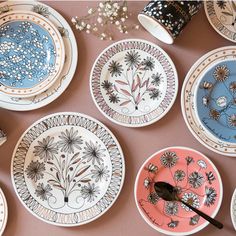 several plates with designs on them are sitting on the table