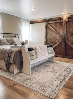 a large bed sitting on top of a wooden floor