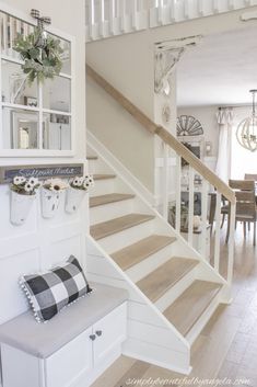 a white staircase leading up to a dining room table