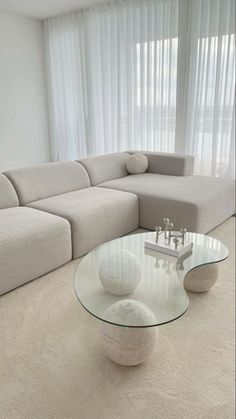 a modern living room with white furniture and curtains