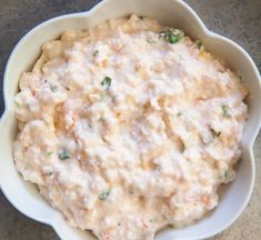 a white bowl filled with food on top of a table