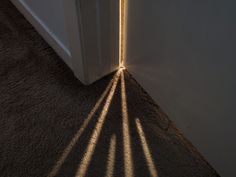 the shadow of a door is cast on the floor