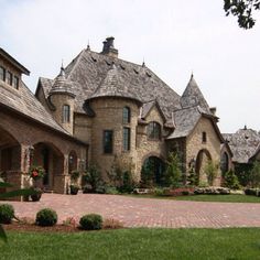 a large brick driveway in front of a house