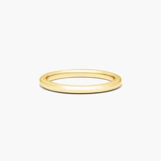 a plain gold ring on a white background