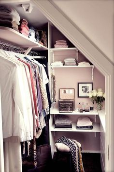 an open closet with clothes and other items