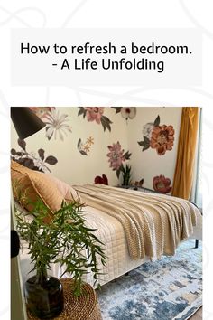 a bed room with a neatly made bed next to a plant