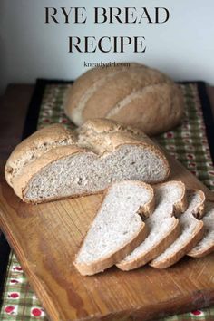 sliced rye bread sitting on top of a wooden cutting board next to slices of bread