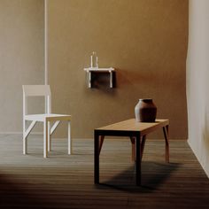 an empty room with a table, chair and shelf on the wall next to it