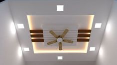 a ceiling fan mounted to the side of a wall in a room with white walls