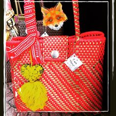 an image of a red purse with a fox on it