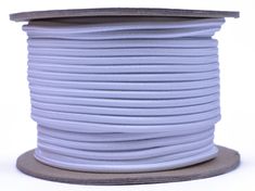 a spool of light blue colored cord on a white background