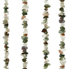 multicolored stone beads are hanging from a line on a white background, each bead has different shapes and sizes