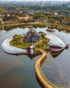 an aerial view of a building in the middle of water