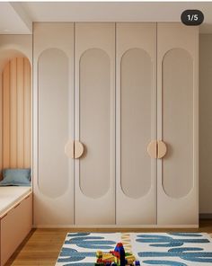 a child's room with white cupboards and toys on the floor in front of it