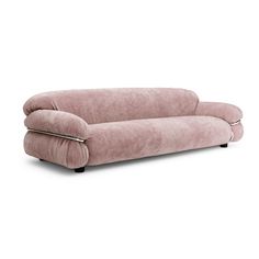 a pink couch sitting on top of a white floor