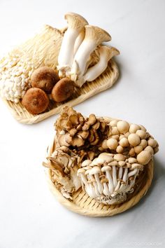 two baskets filled with different types of mushrooms