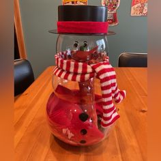 a snowman in a fish bowl on a table