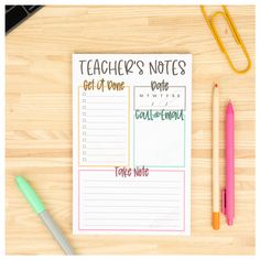 a notepad and pen sitting on top of a wooden table