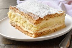 a piece of cake sitting on top of a white plate next to a knife and fork