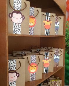 there are many bags with animals on them in the store display case for children's birthdays