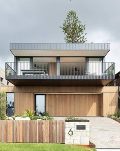 a modern house with wooden siding and balconies