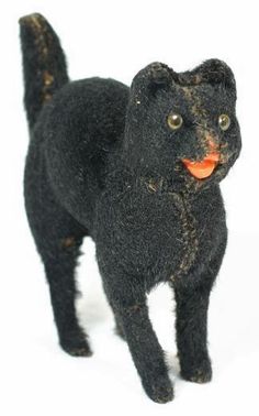 a black cat with an orange collar on it's head and tail, standing in front of a white background