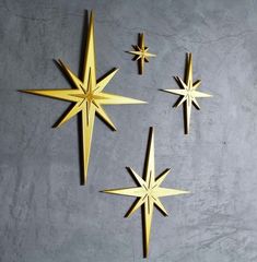 three gold stars are hanging on the wall