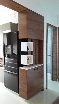 a modern kitchen with wooden cabinets and white flooring