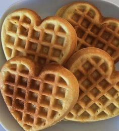 three heart shaped waffles on a white plate