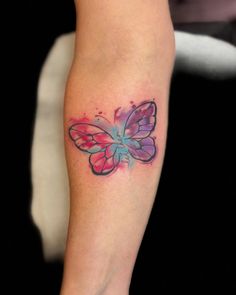 a colorful butterfly tattoo on the leg