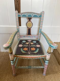 an ornately decorated wooden chair sitting in front of a door