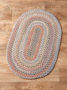 an oval rug on a wooden floor