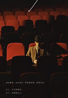 a man sitting in an empty theater seat