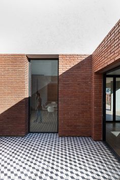 an empty room with black and white checkered flooring on the side of it