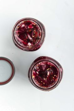 three glasses filled with liquid sitting on top of a white table next to each other