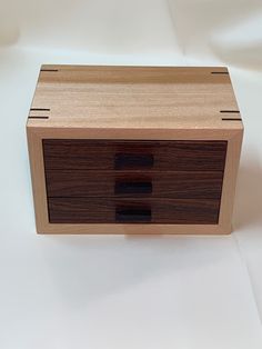 a wooden box sitting on top of a white table