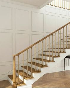 a white and gold staircase in an empty room