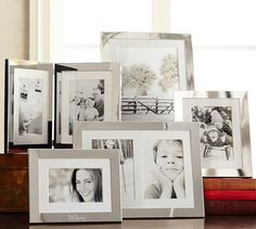 a group of framed pictures sitting on top of a table