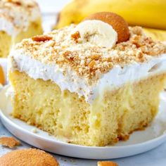 a close up of a piece of cake on a plate with bananas in the background