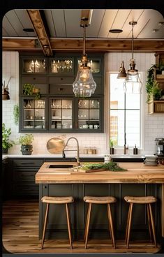 a kitchen with wooden floors and black cabinets