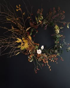 an image of a wreath made out of flowers and leaves on a black background with the words joybutta above it