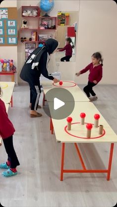 two girls and one boy are playing table tennis