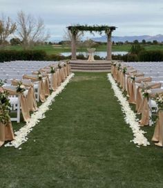 an outdoor wedding setup with chairs and flowers