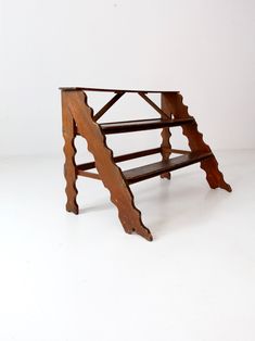 an old wooden bench sitting on top of a white floor